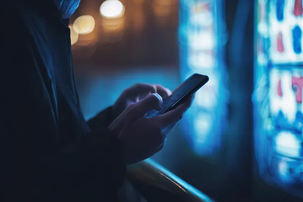 A glamorous woman holding casino chips in a neon-lit environment, representing the premium online casino atmosphere of BETWINNER.