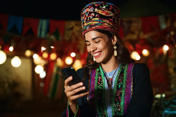 A confident dealer surrounded by casino chips inviting players to access their BETWINNER account, reflecting quick and easy login options.